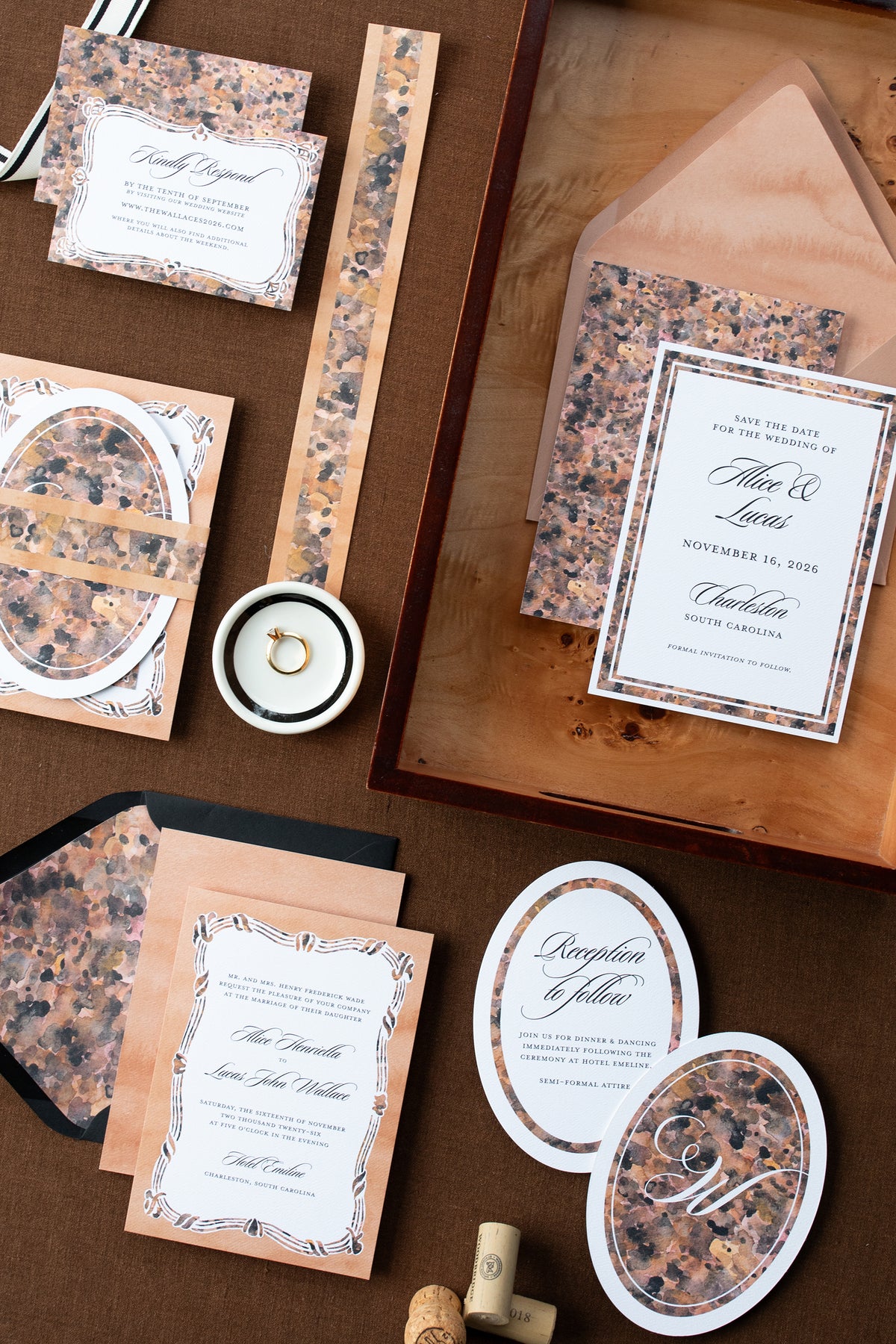 Collection of wedding invitations and stationery items on a brown surface