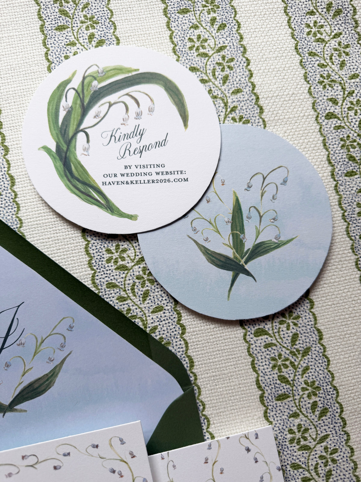 Round wedding invitation cards with floral designs on a textured surface