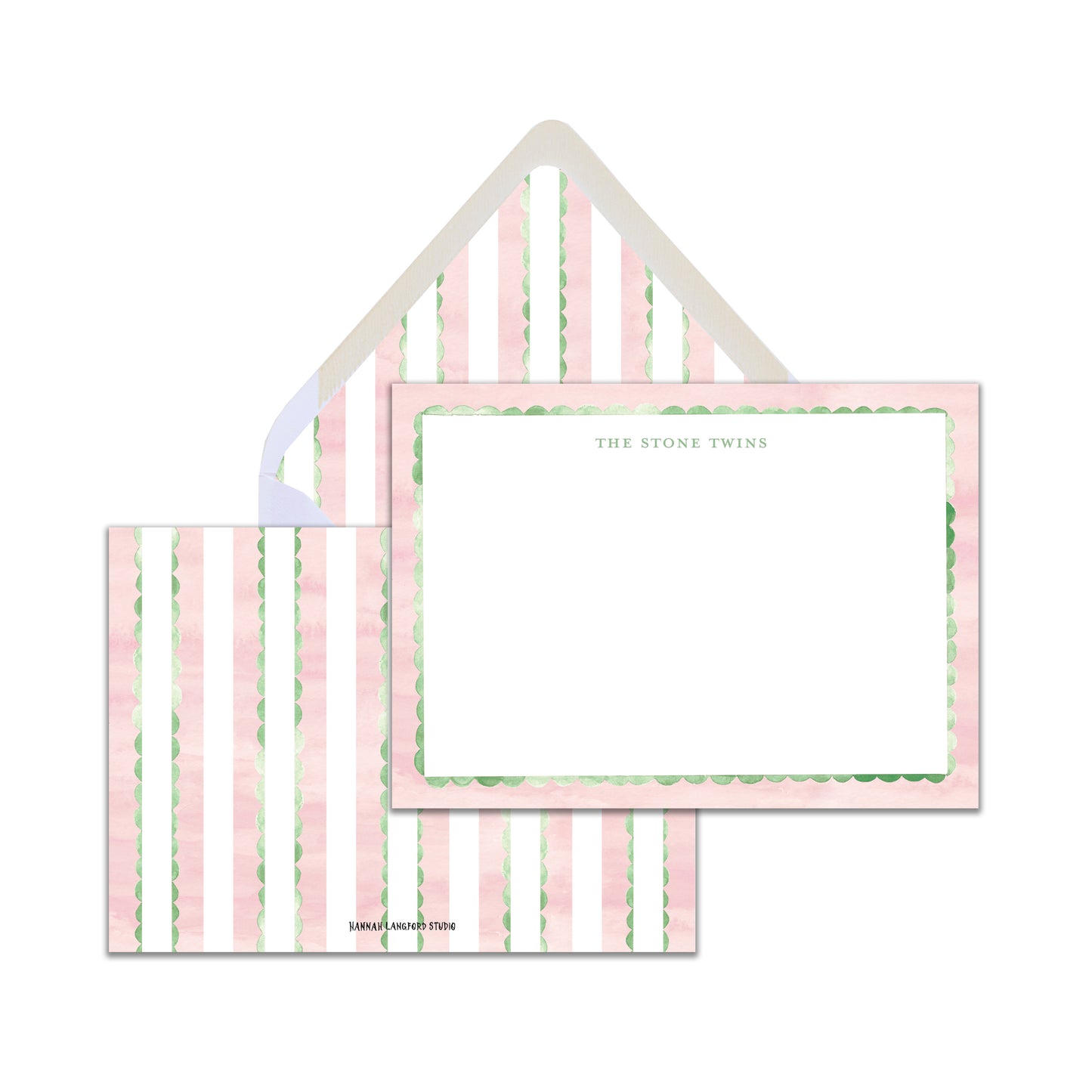 A set of pink and green striped stationery with a beaded border and a white envelope.