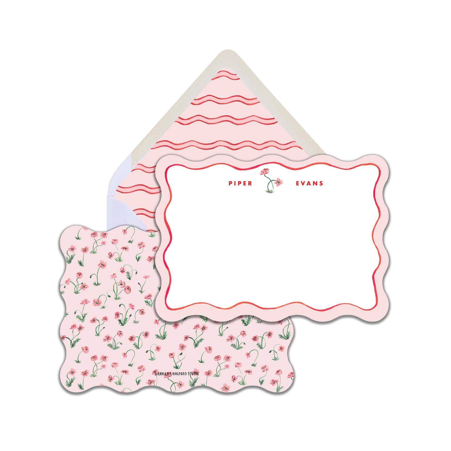 A set of floral stationery with a scalloped edge design, including a card and envelope, predominantly pink and red.