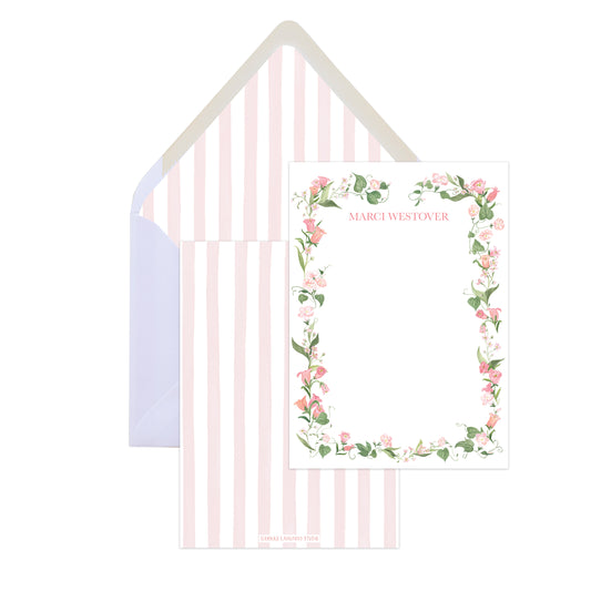 Floral wreath design card with striped envelope on a white background