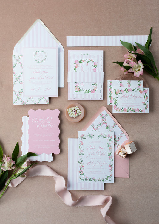 Set of floral stationery items on a pink background