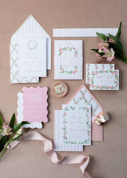 Set of floral stationery items on a pink background