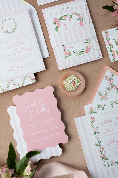 Invitation cards with floral designs and text on a pink surface.