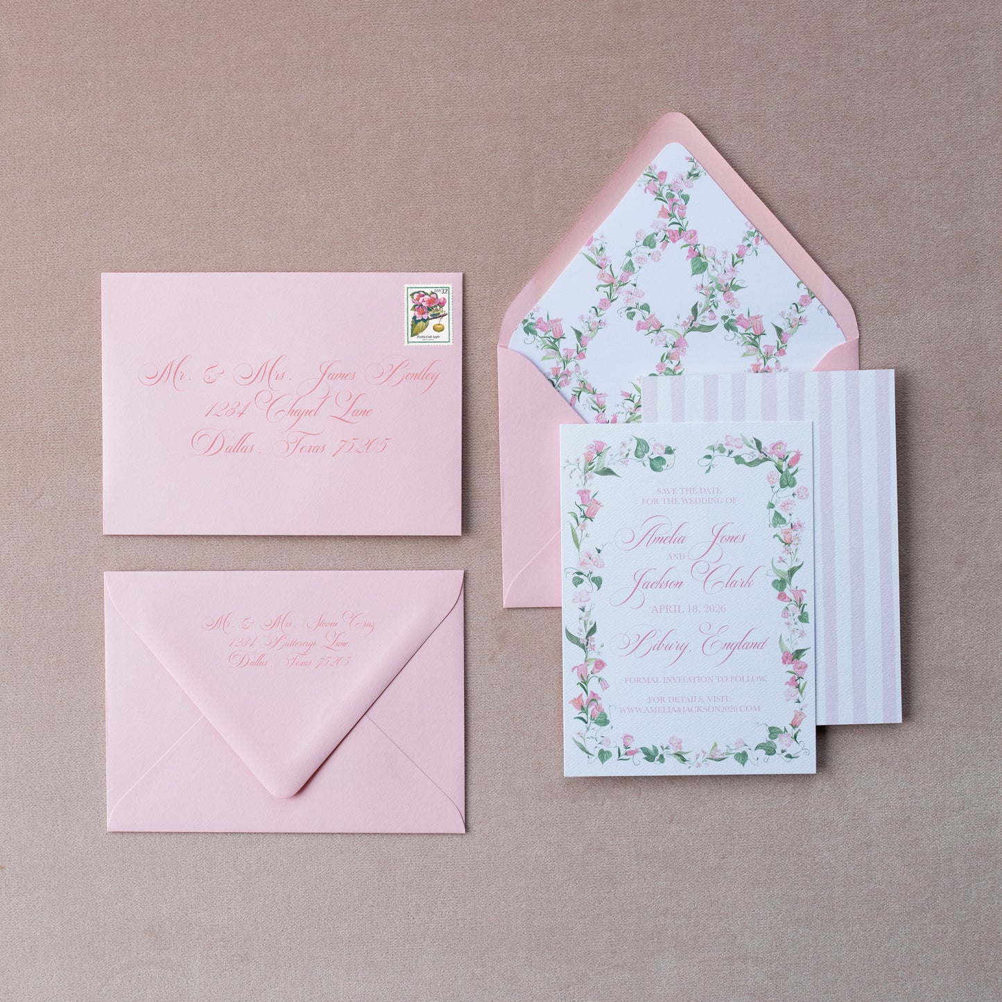 Set of pink envelopes and floral stationery on a pink background