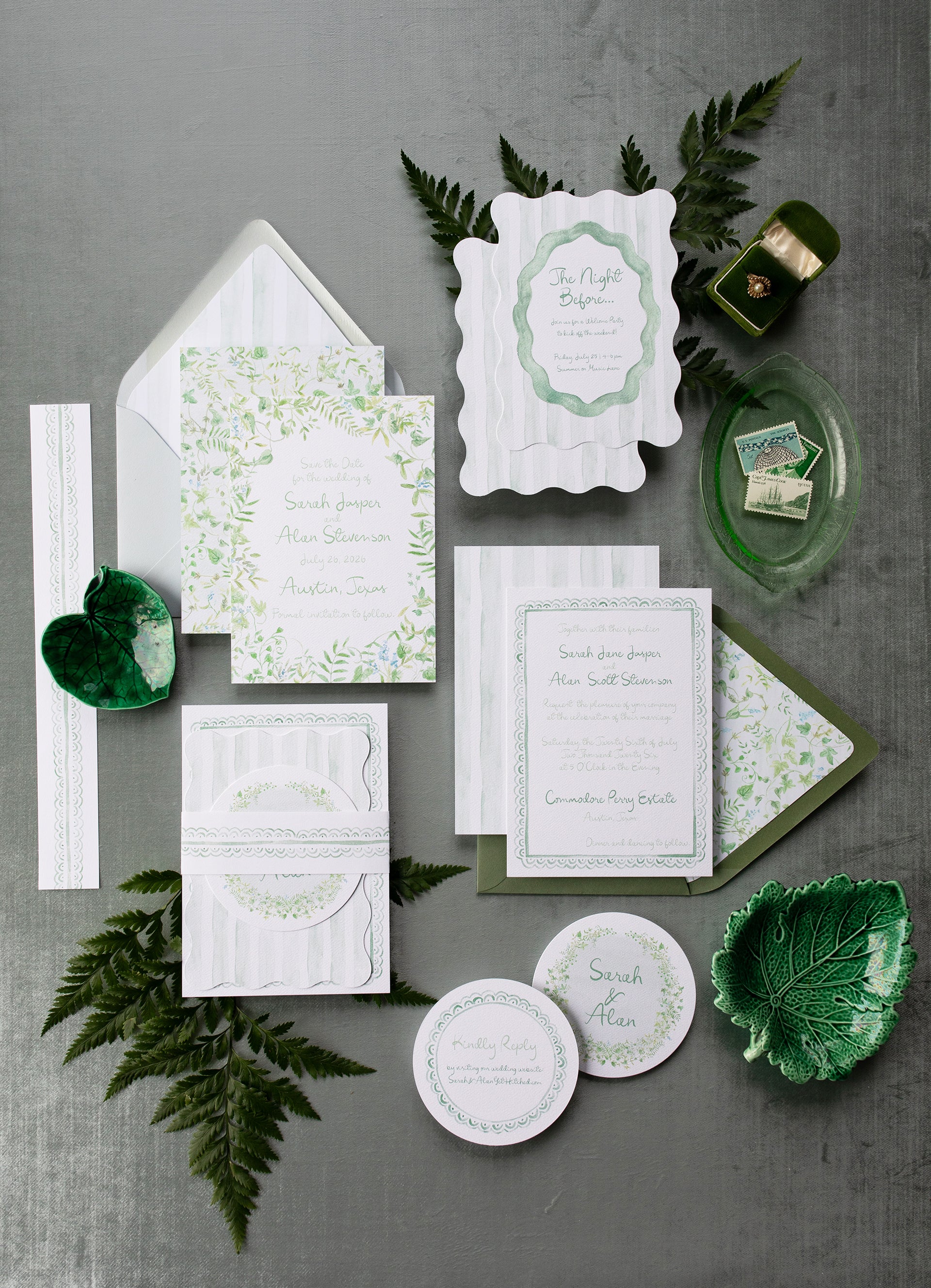 Green and white stationery set with leaves on a gray background