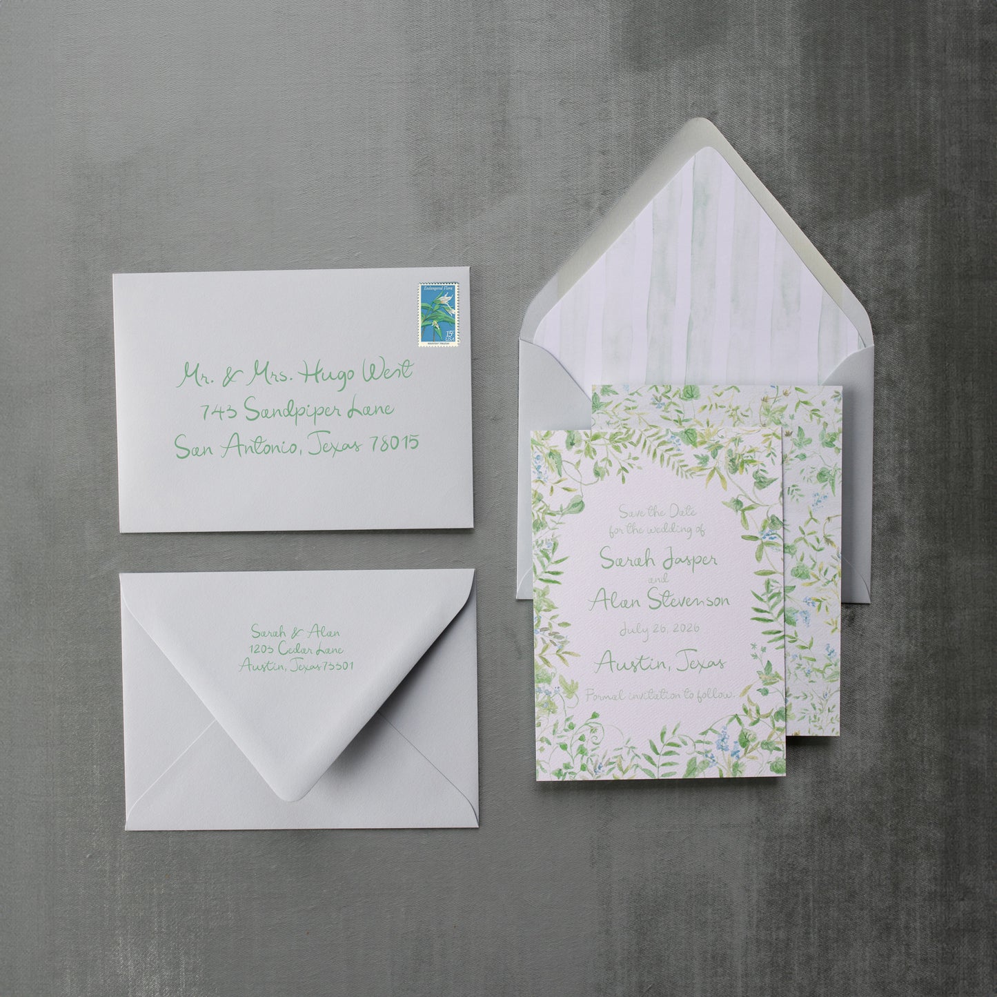 Set of wedding invitations with envelopes on a gray background