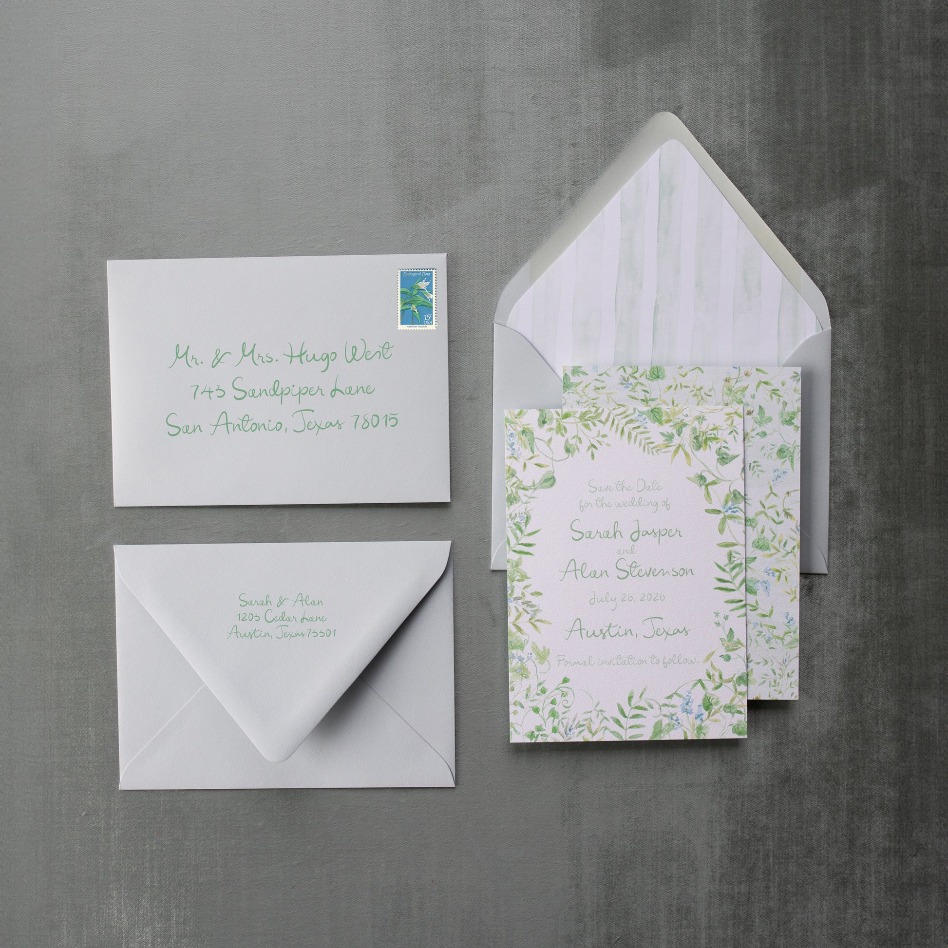 Set of wedding invitations with envelopes on a gray background