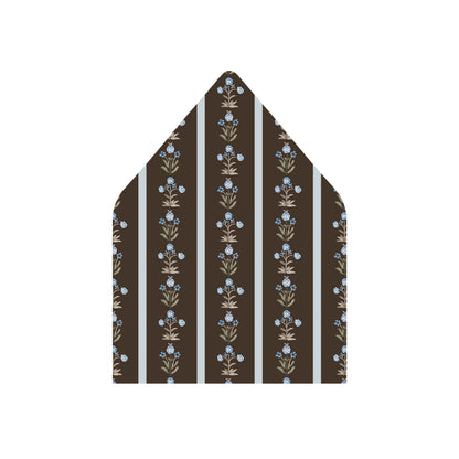 A pointed envelope flap or paper insert with a dark brown background, vertical white stripes, and a repeating floral pattern in beige and light blue, shown on a plain white background.