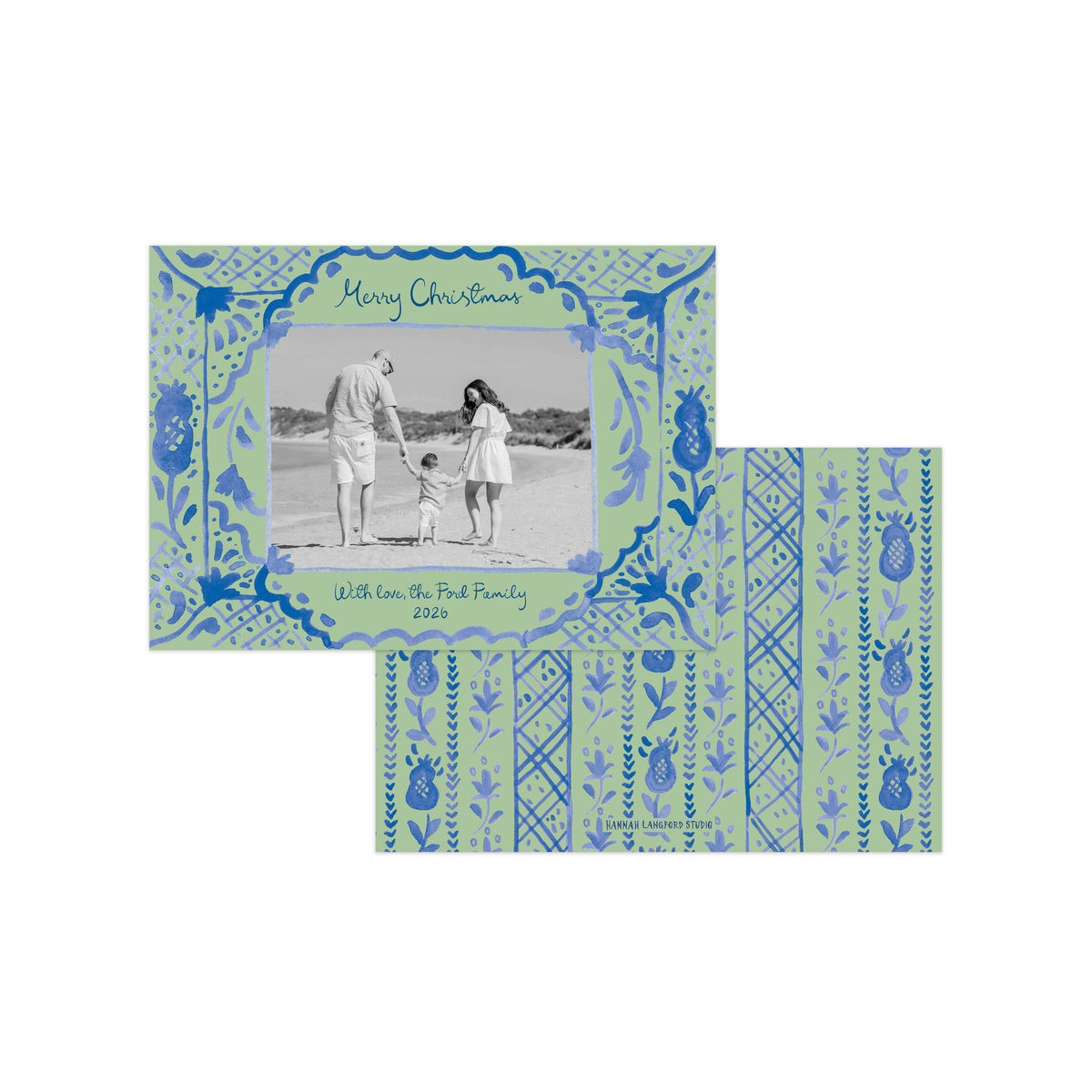 A personalized Christmas photo card with a light green and blue patterned border, featuring a black-and-white family beach photograph in the center and matching patterned cardstock sheets behind it on a white background.