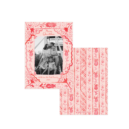 A pink and red patterned Christmas photo card set shown on a white background, with one card displaying a family photo and the other showing the back design.