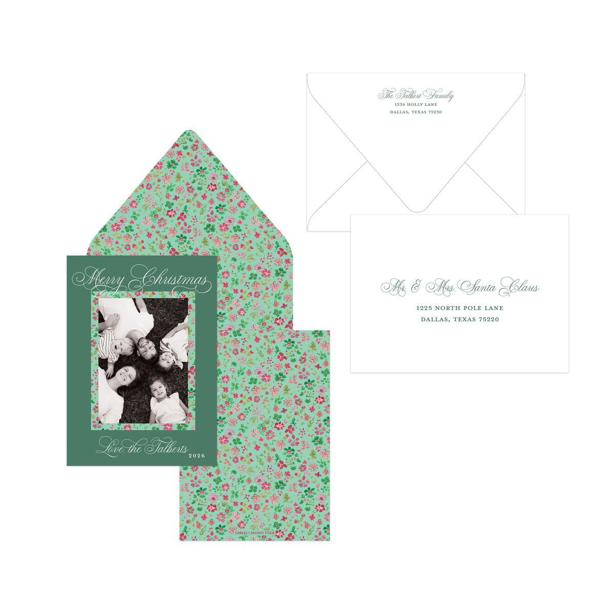 Personalized Christmas invitation suite featuring a dark green front card with a family photo placeholder, a matching floral envelope liner in mint green with pink and red flowers, and a white envelope.