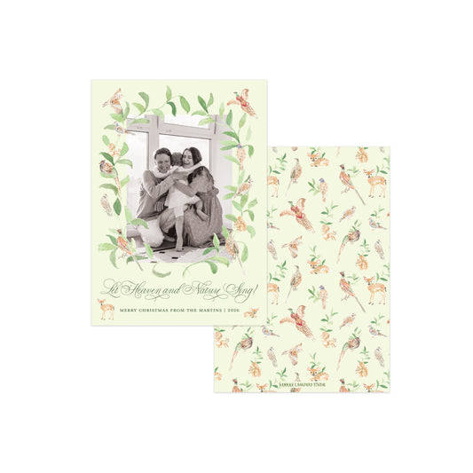 A Christmas greeting card set with a front cover featuring a vintage-style family photo framed by green leaves and small birds, and a matching patterned card shown behind it on a white background.