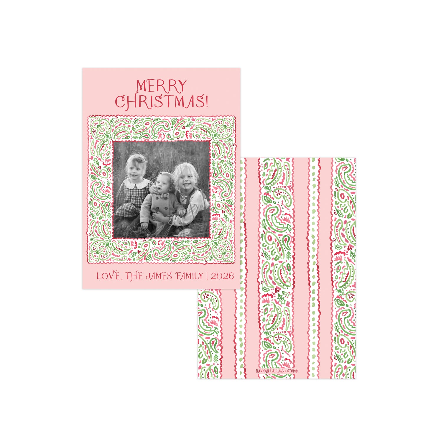 A Christmas greeting card and matching envelope set on a white background. The card is light pink with 'MERRY CHRISTMAS!' at the top, and a central black-and-white family photo framed by a red and green paisley border.