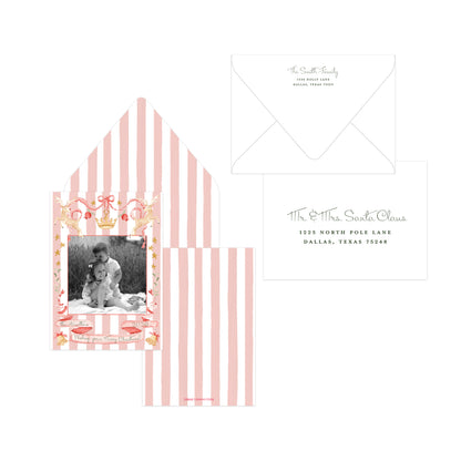 Pink and white striped Christmas card featuring a custom photo insert, matching striped envelope, and a white address card with elegant script text.
