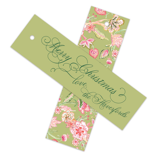 Two rectangular Christmas gift tags with a sage green background, featuring a pink floral pattern on the right side and elegant cursive writing on the left. One tag reads 'Merry Christmas love, the Haverfords'.
