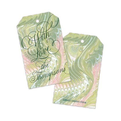 Two personalized gift tags with a green, pink, and white marbled pattern, featuring the text 'With Love the Thompsons' .
