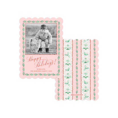 A set of personalized holiday photo cards on a white background. One card is shown with a family photo in a scalloped pink border with green holly patterns and the text 'Happy Holidays! With love, The Martinez Family | 2025'.