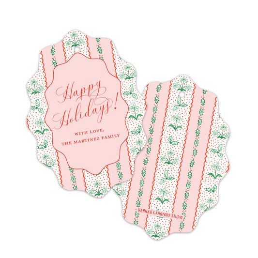 Two scalloped holiday gift tags with a pink and white striped pattern, green botanical motifs, and red text. 