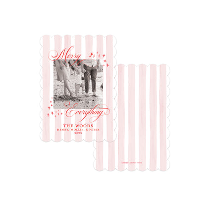 Two personalized holiday photo cards with pale pink vertical scalloped stripes on a white background. One card shows a black-and-white family photo with red script text reading 'Merry Everything' and names below, while the other card shows only the striped design.