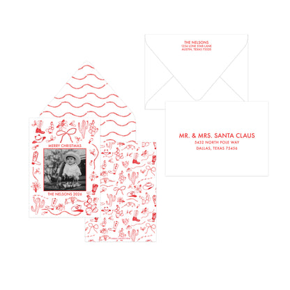 A personalized Christmas invitation suite featuring a main card with red hand-drawn holiday illustrations and a photo frame, an open matching envelope with red wavy line art, and a second white envelope with red printed text.