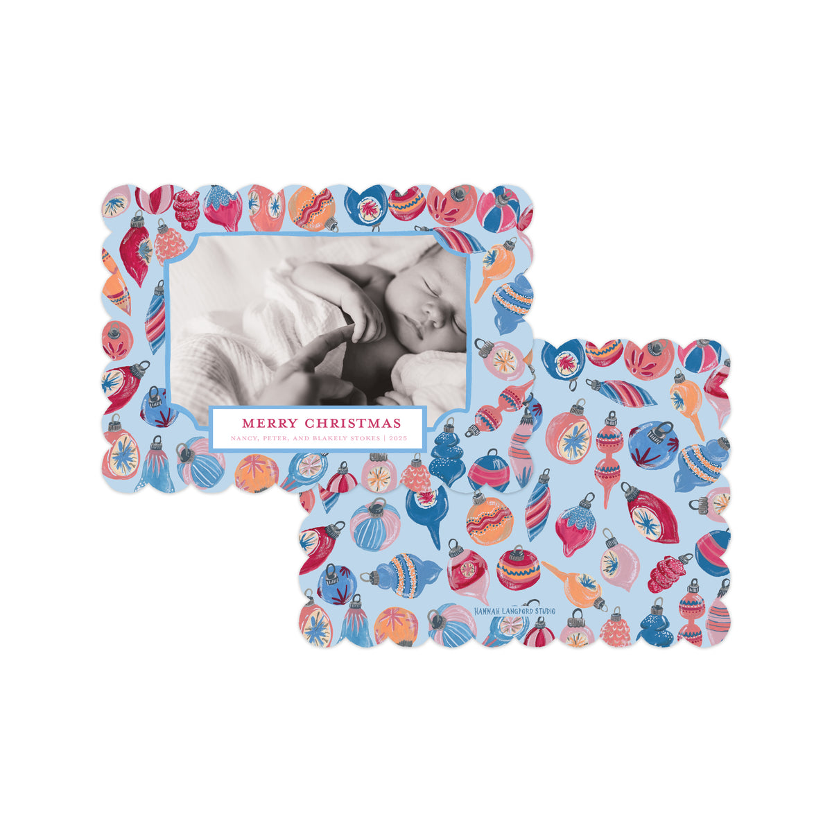 Two Christmas-themed photo frames with scalloped edges, featuring a light blue background patterned with colorful ornaments and a black-and-white baby photo insert on one frame, shown on a white background.