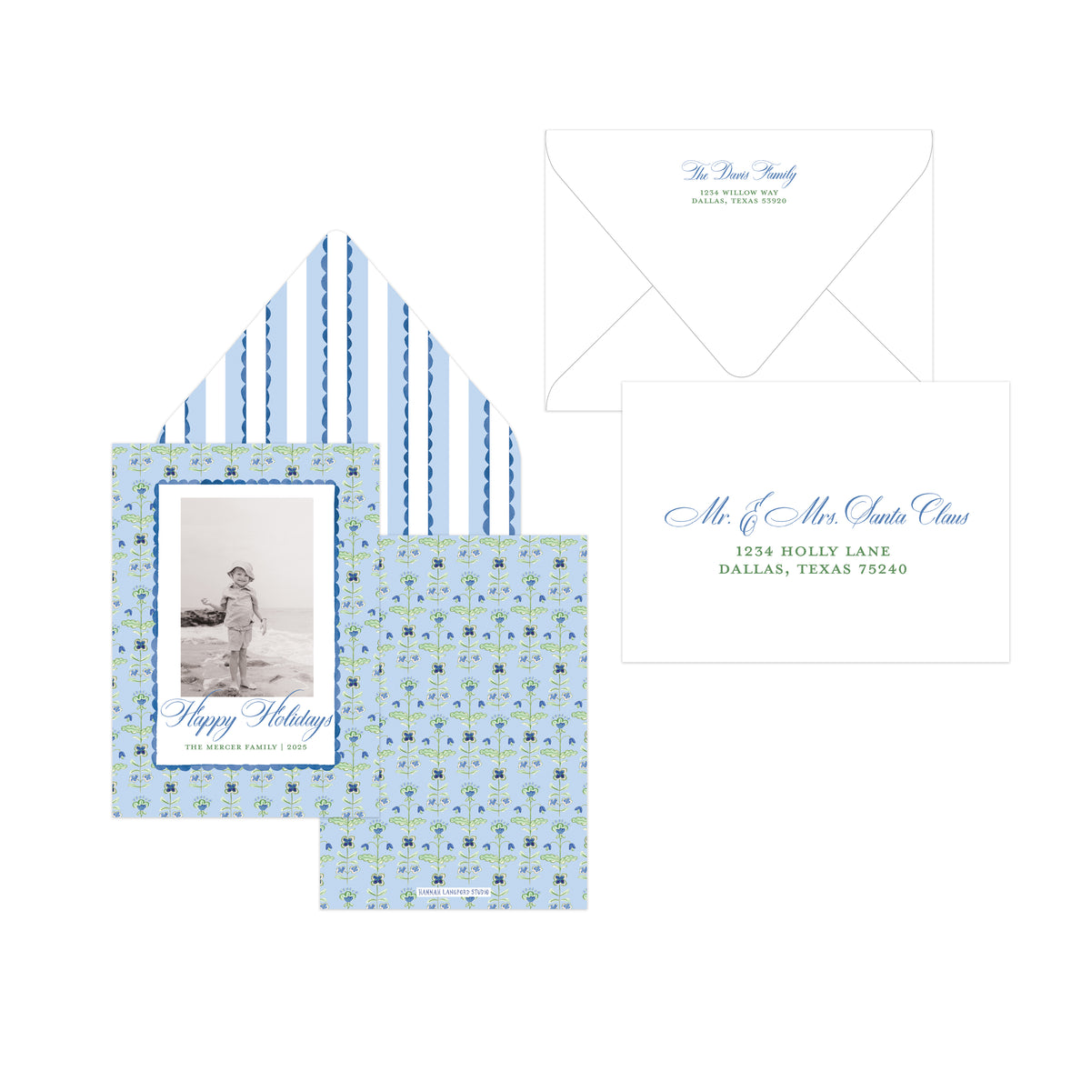 A holiday stationery set displayed on a white background, including a patterned greeting card, matching envelope liner, white envelope, and a white address card with blue script text.