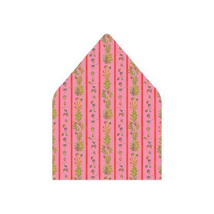 A pointed envelope flap or paper envelope with a pink background and vertical stripes featuring green botanical illustrations, shown on a plain white background.