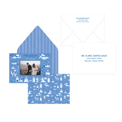 Blue and white personalized Christmas invitation suite featuring a striped envelope, patterned card with a photo insert, and a matching address card on a white background.