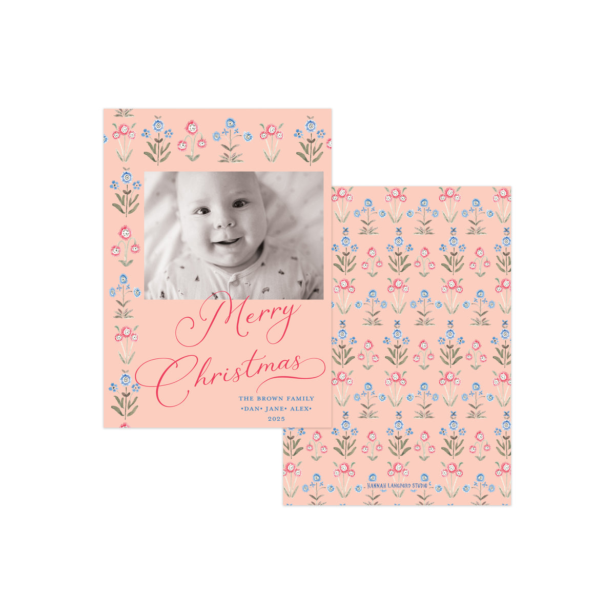 Two personalized Christmas photo cards with a soft peach background and a delicate floral border pattern in pink, blue, and green. One card features a baby's black-and-white photo with 'Merry Christmas' written in pink script, and the other shows the repeating floral pattern.