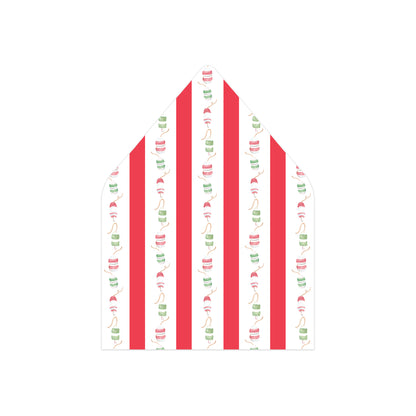 A white envelope liner or gift bag liner with a festive pattern of vertical red stripes and small green and red candy cane motifs.