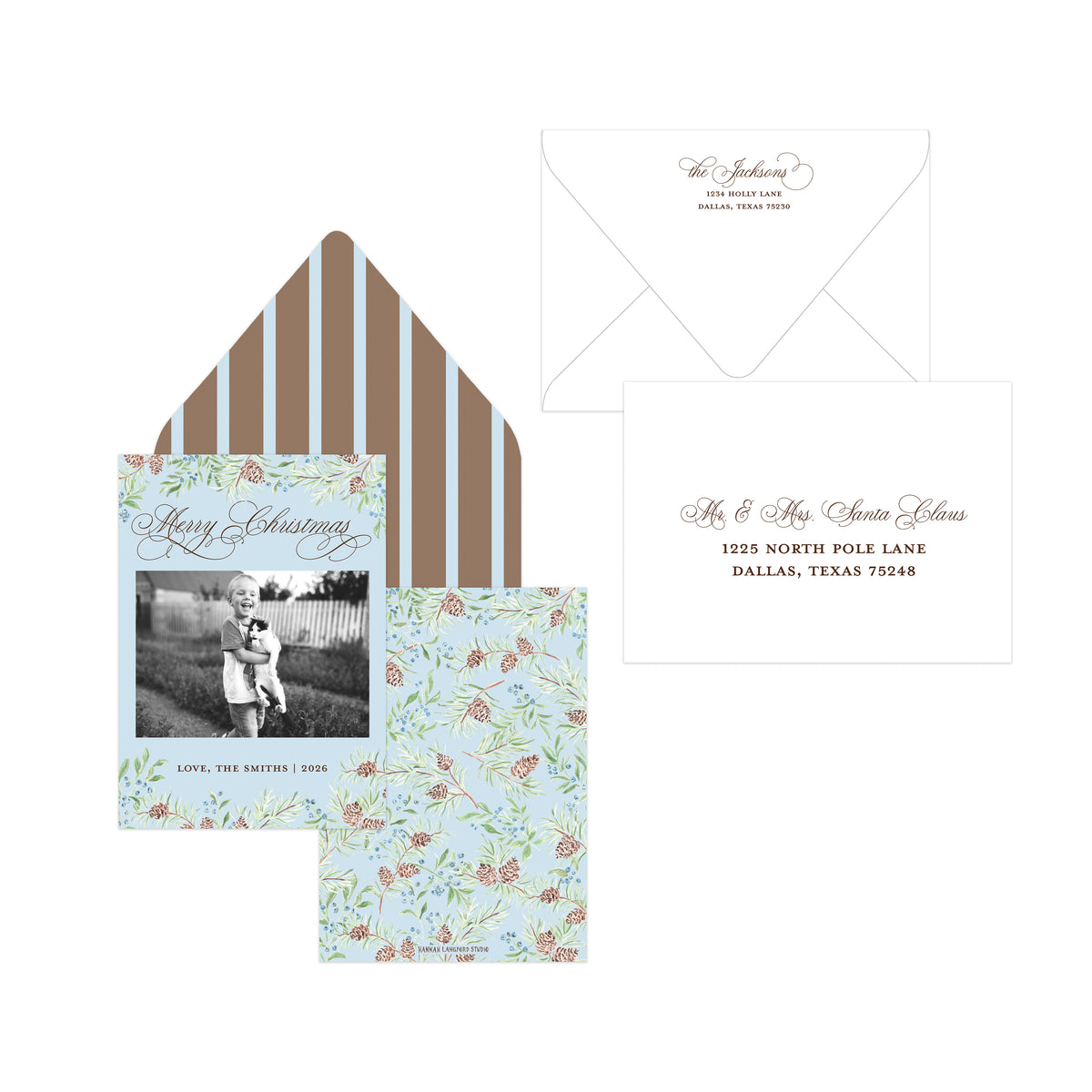 A coordinated Christmas stationery set on a white background, including a floral greeting card with a black-and-white family photo, a matching floral envelope liner with brown vertical stripes, a white envelope with cursive script, and a white address card with brown text.