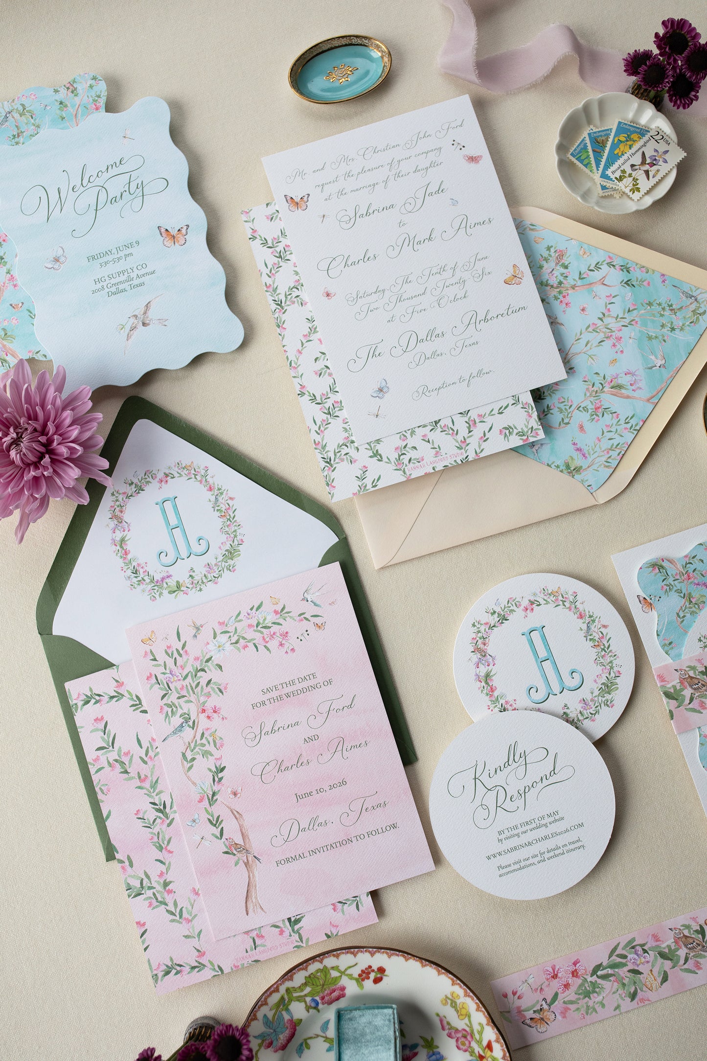 Collection of floral wedding invitations and stationery on a neutral background