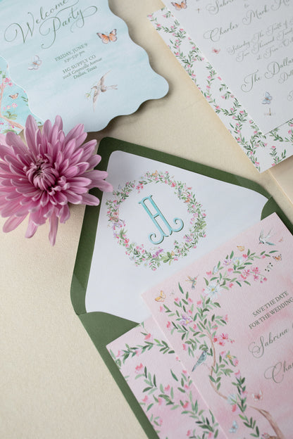 Collection of floral wedding invitations with a pink flower on a beige background