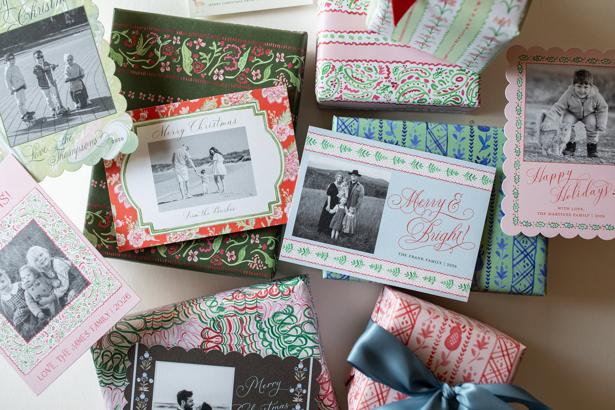 Holiday cards and wrapped presents on a white background.