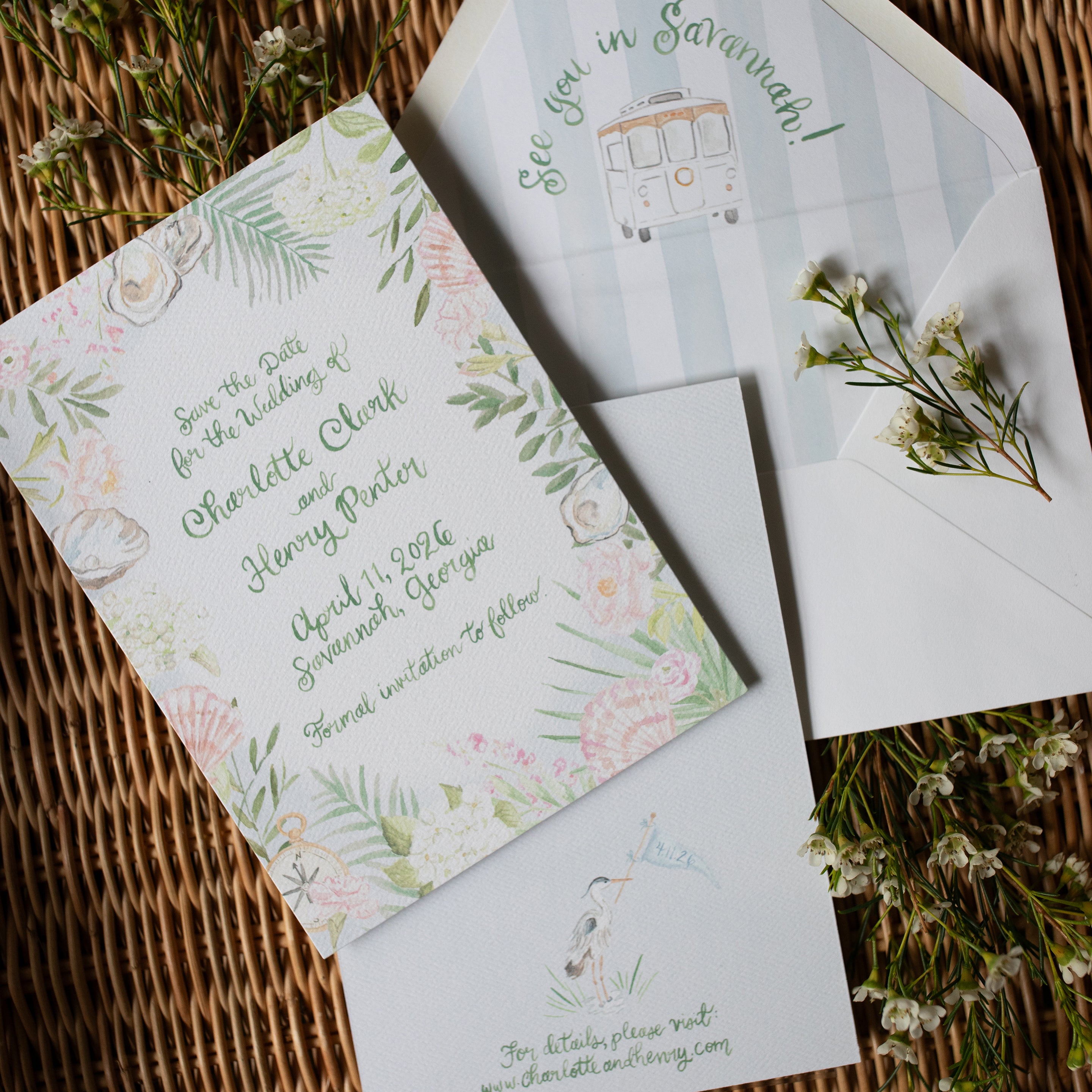 Wedding invitation set with floral design and text on a woven surface.