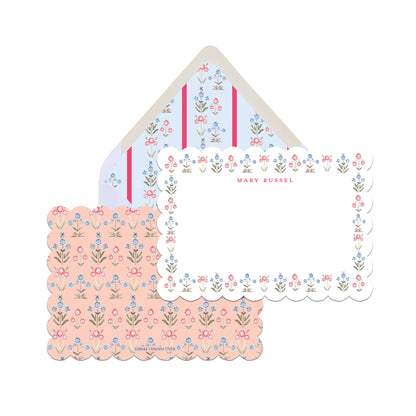 Set of floral stationery items including an envelope and cards on a white background