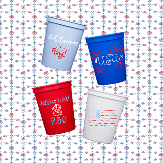 Four festive cups with text and designs on a patriotic patterned background
