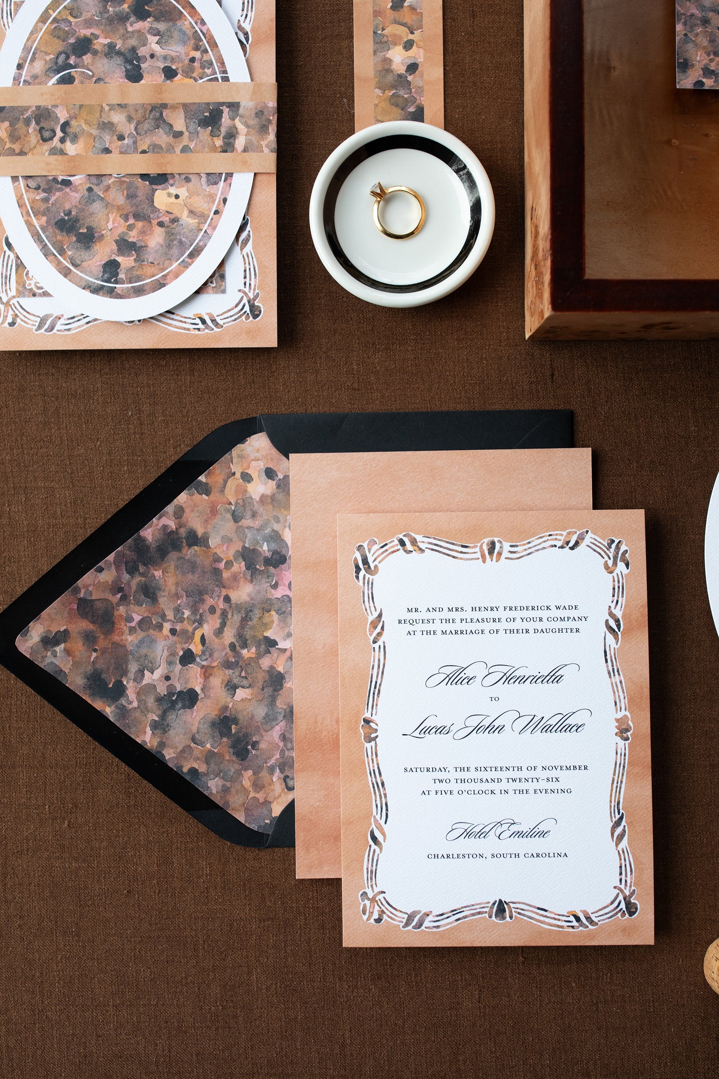 Wedding invitation card with decorative envelope on a brown surface