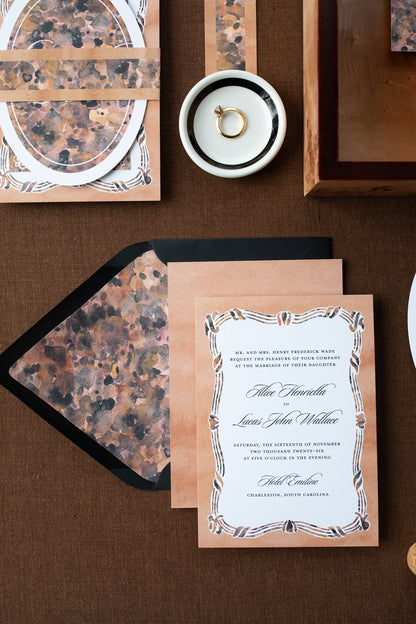 Wedding invitation card with decorative envelope on a brown surface