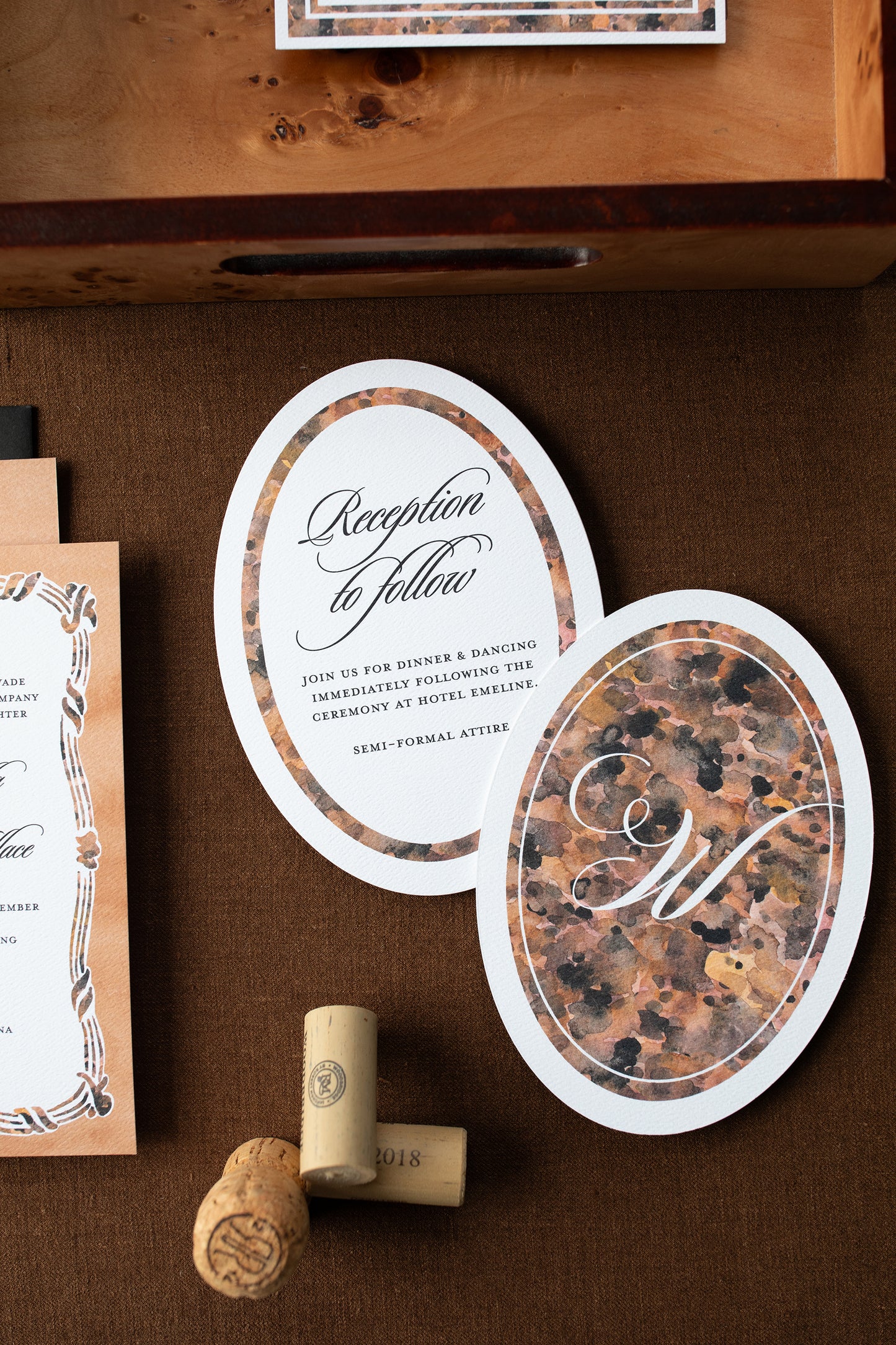 Elegant wedding invitations with cork and wooden surface
