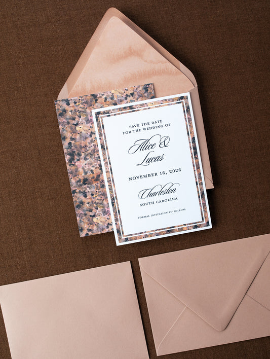 Wedding save the date card with a patterned envelope on a brown background