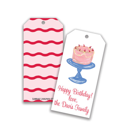 Two gift tags with birthday cake illustrations and customizable text. One with red stripes and the other featuring a cake on a stand with a personalized message.