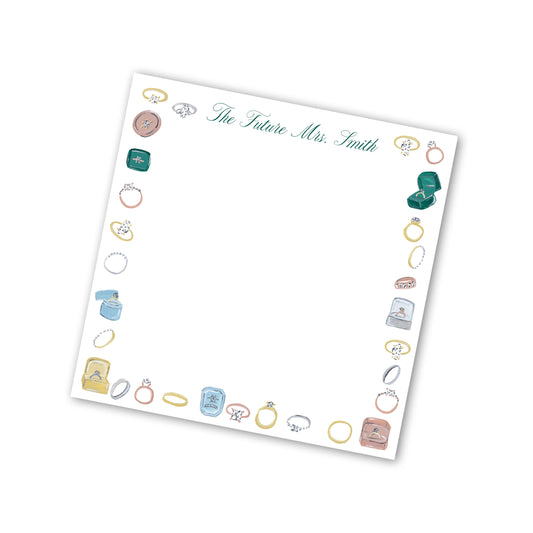 notepad with illustrations of rings and text that says "the future Mrs. Smith".