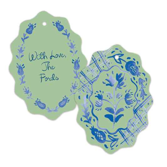 Two decorative scalloped paper tags with blue floral and bird illustrations on a light green background, one tag reading 'With Love, The Fords' and the other showing a matching patterned side.