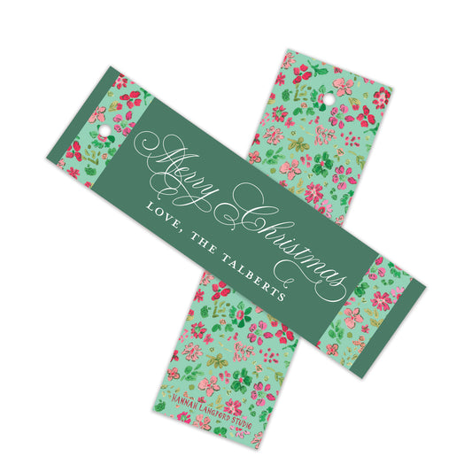 Two Christmas gift tags with a floral pattern on a mint green background, featuring a dark green central band with white cursive text reading 'Merry Christmas' and 'LOVE, THE TALBERTS'.
