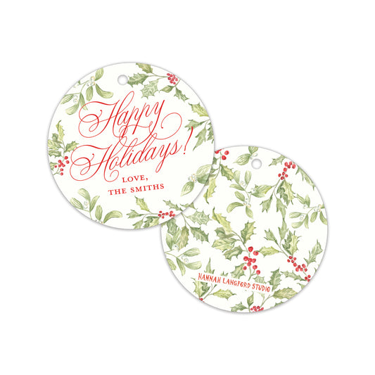 Two personalized round holiday gift tags with a white background, green holly leaf pattern, and red berries. One tag displays 'Happy Holidays! LOVE, THE SMITHS' in red script.