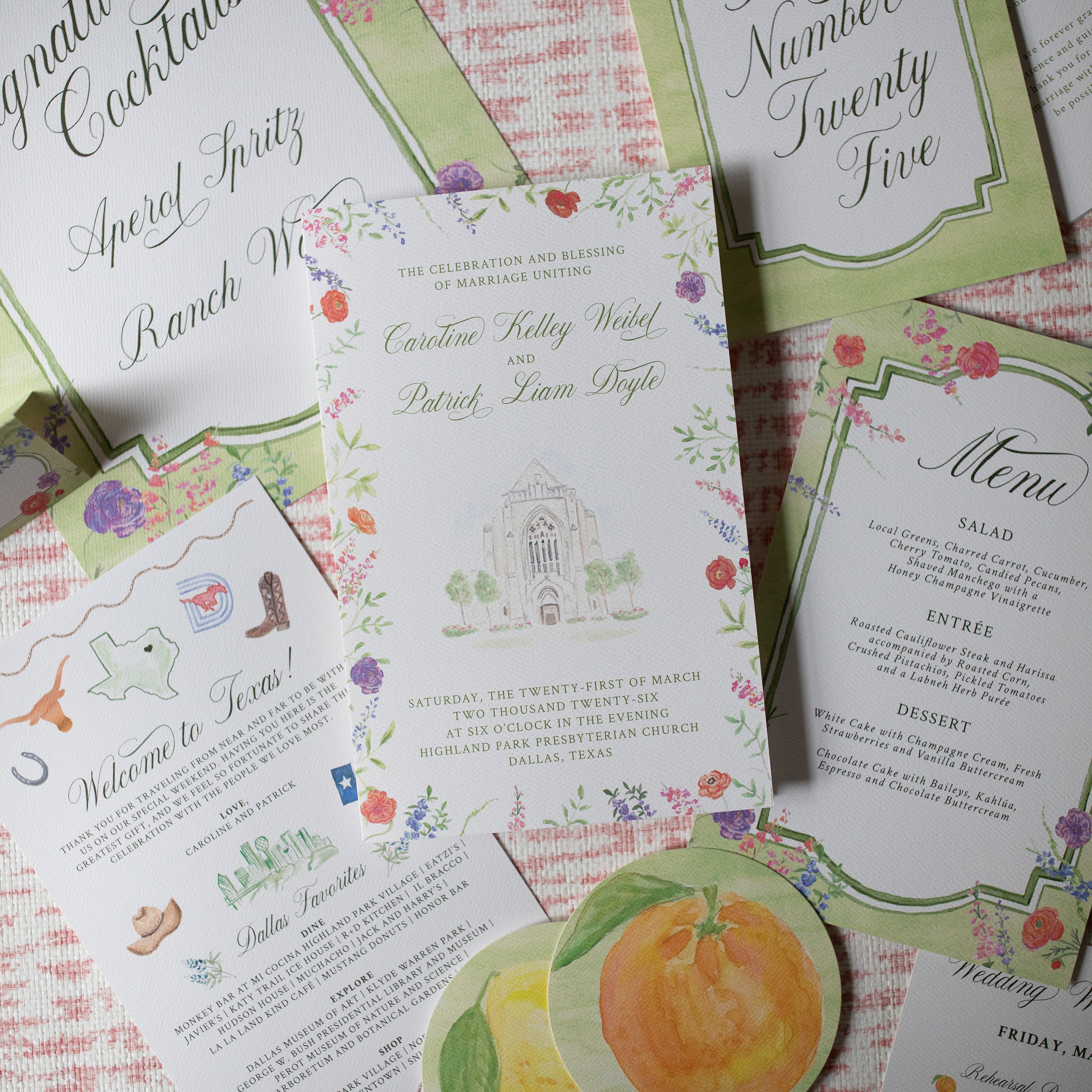 Collection of wedding invitations and stationery items on a patterned surface