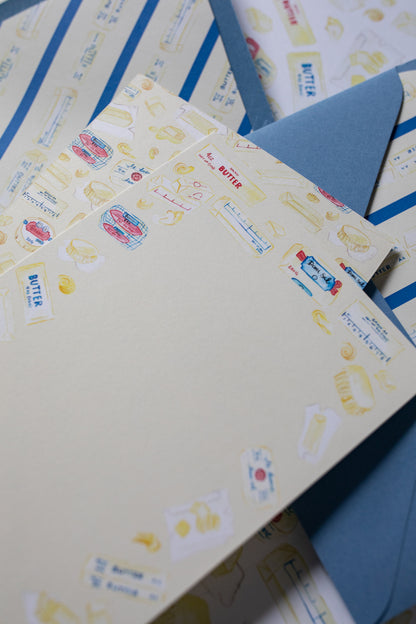 stationery cards with butter illustrations on a patterned background