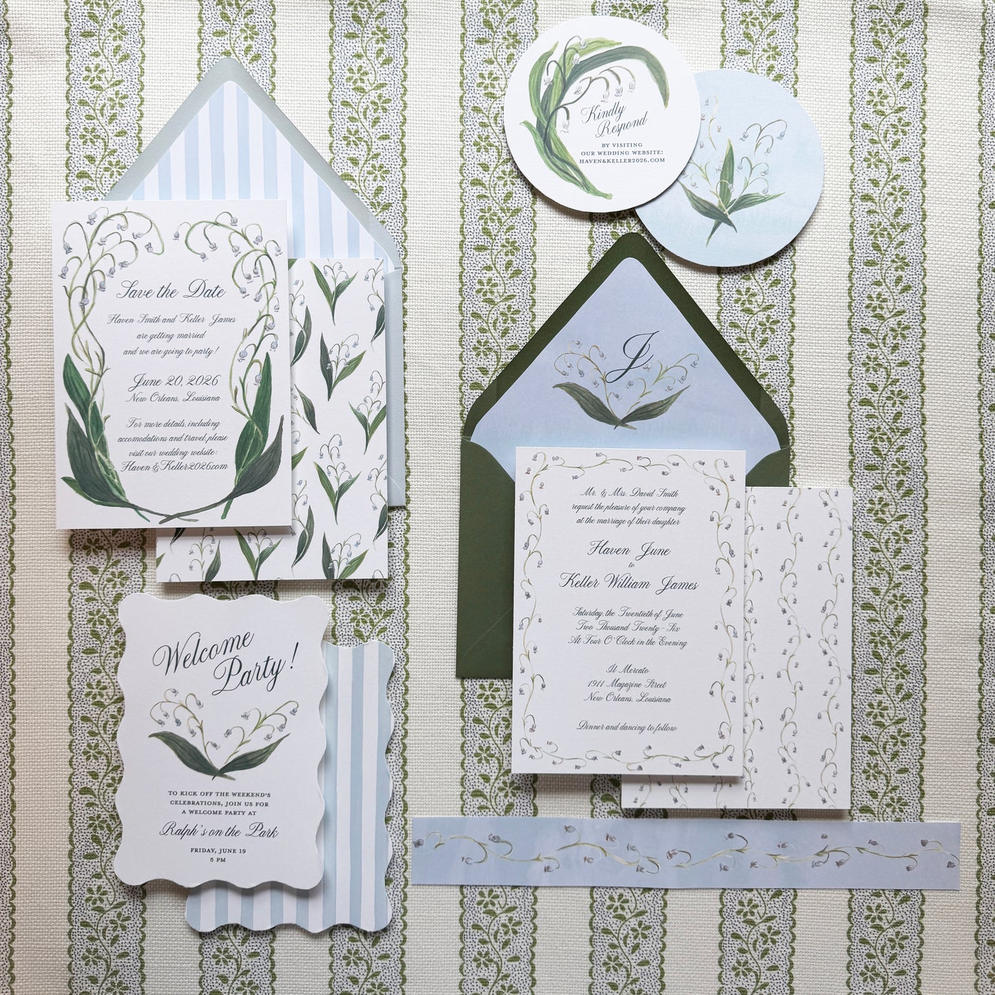 Wedding invitation set with greenery design on a textured background
